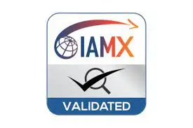 Logo IAMX validated, globe et avion stylisés, texte "VALIDATED" en bas. Intègre le concept de checklist déménagement entreprise par l’idée d’une démarche validée.